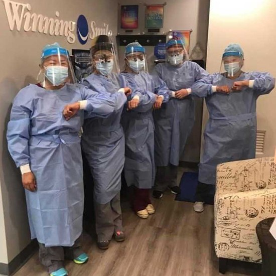 The Winning Smile Dental Group team in safety gear
