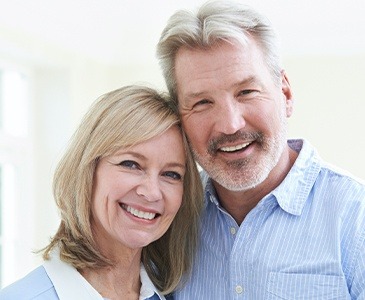 Man and woman with healthy smile after periodontal therapy