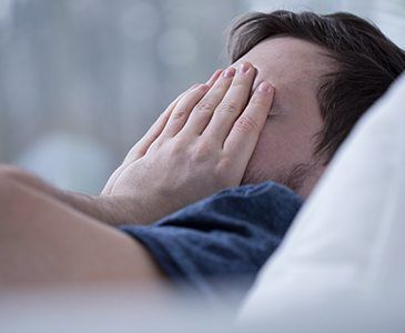 Man in need of sleep apnea therapy waking feeling frustrated